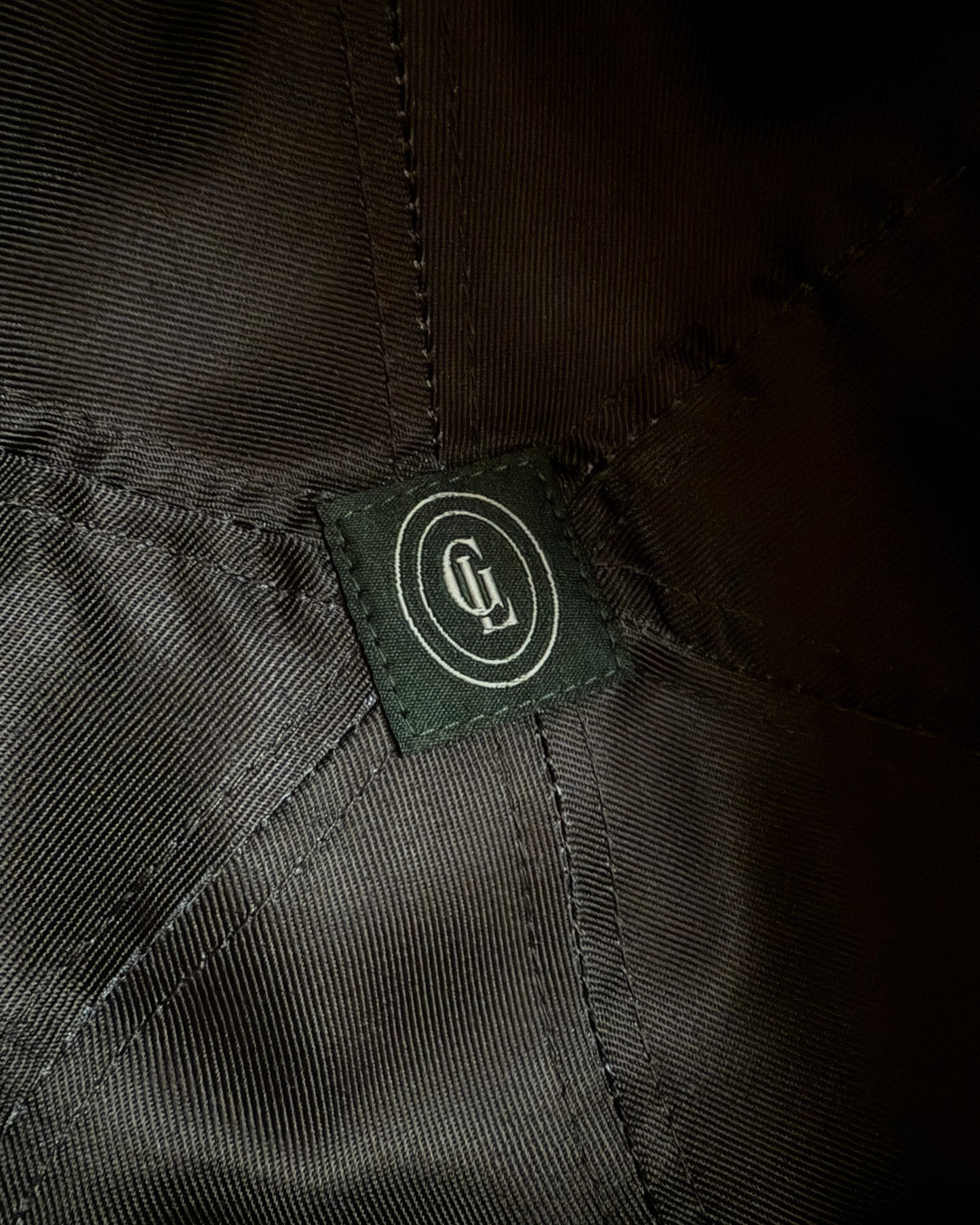 Close-up of a brand label on a dark fabric background